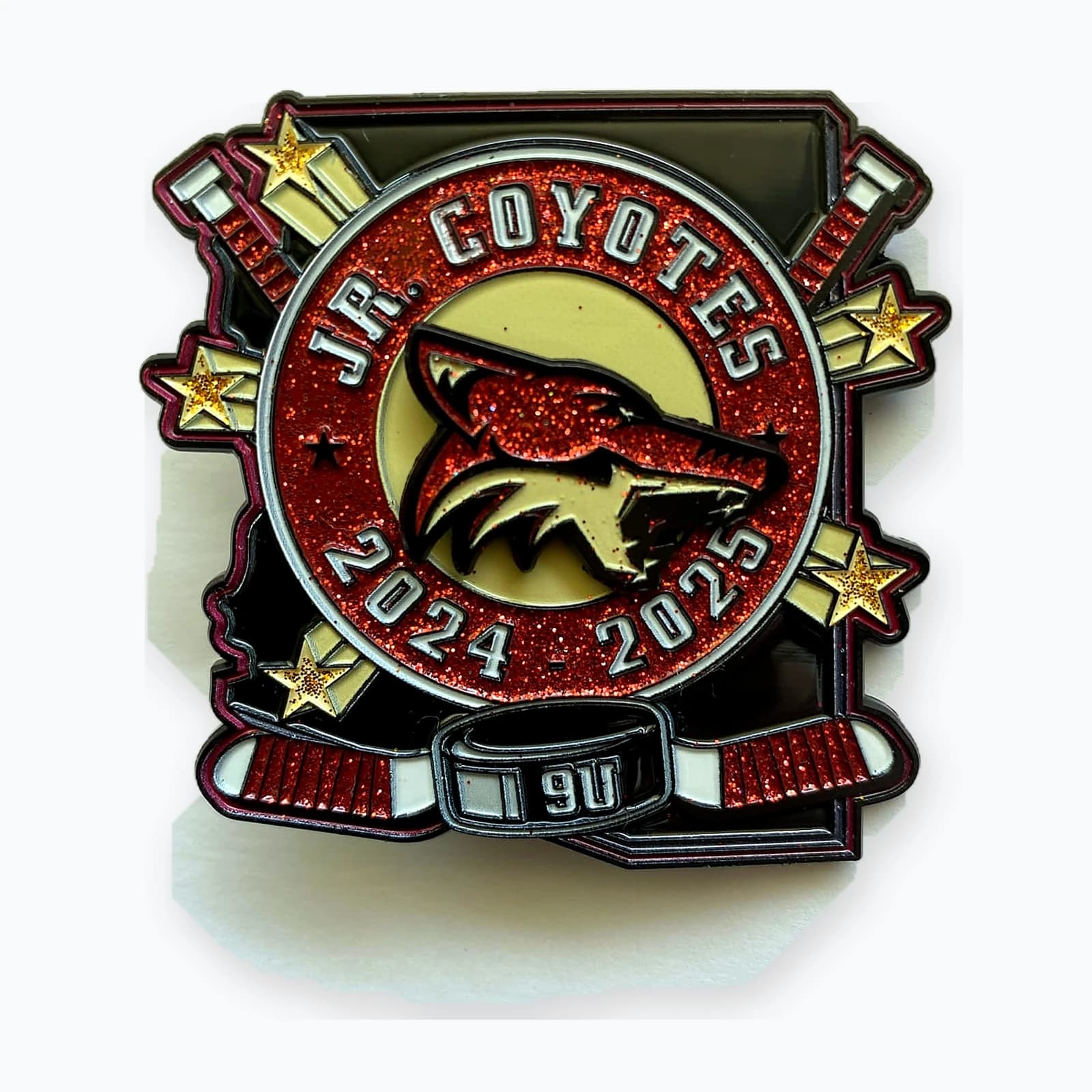 An Arizona Jr. Coyotes trading pin with a coyote mascot