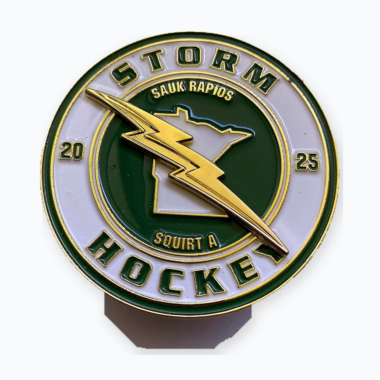 A round Sauk Rapids Storm hockey trading pin