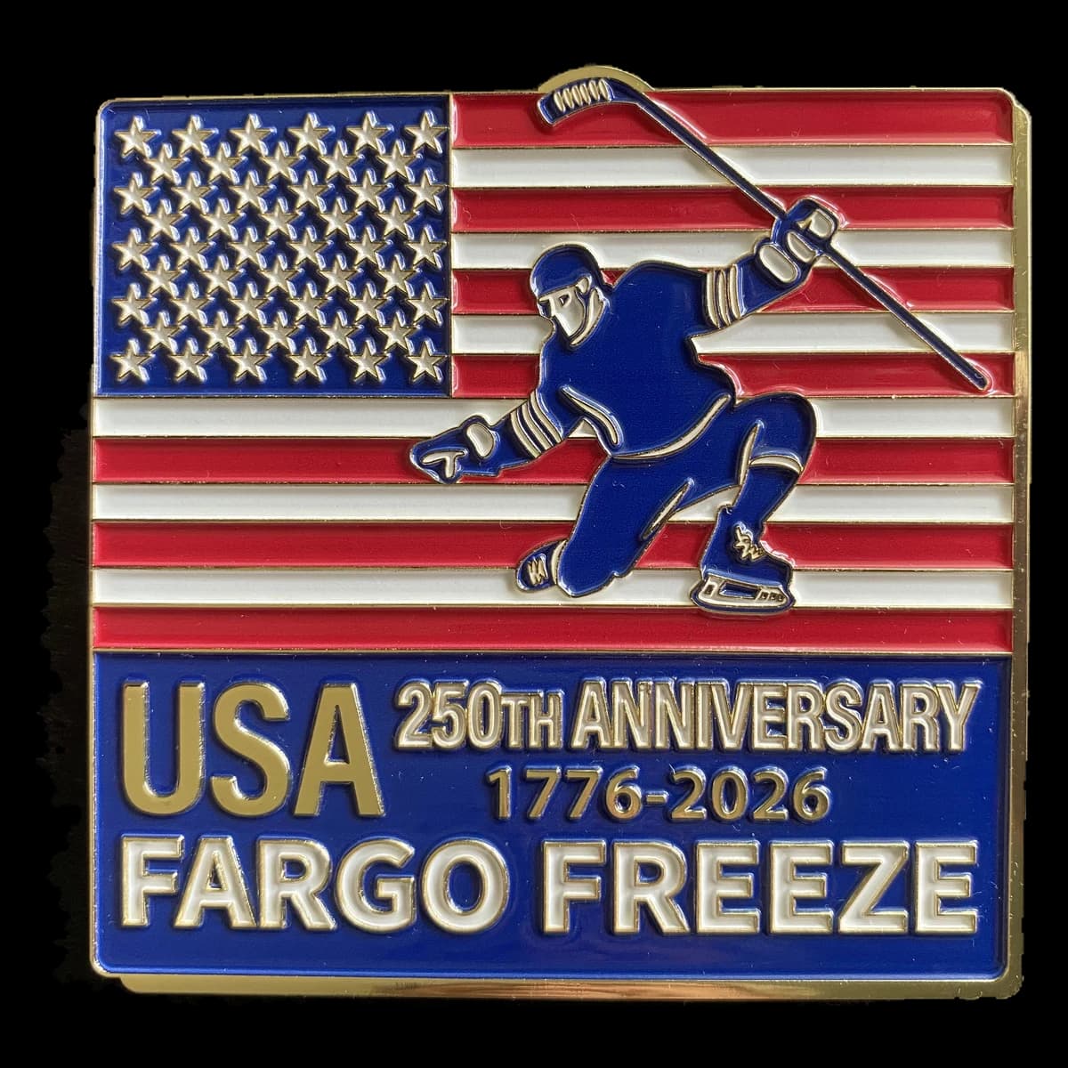 A square Fargo Freeze trading pin with a hockey player skating across an American flag, above USA 250th Anniversary 1776-2026